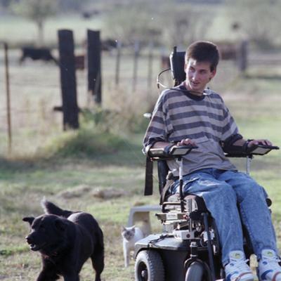 Todd Whitehead, paralyzed, enjoys an outing with his dog Crow