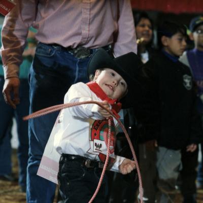 Rodeo for disabled children; young cowboy tries his hand at roping
