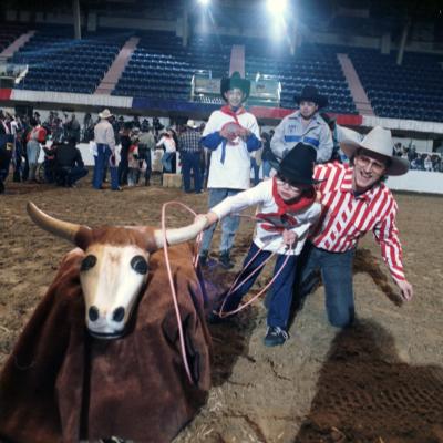 Rodeo for disabled children; cowboy Ron Lewis helps Chris Doss rope a fake steer