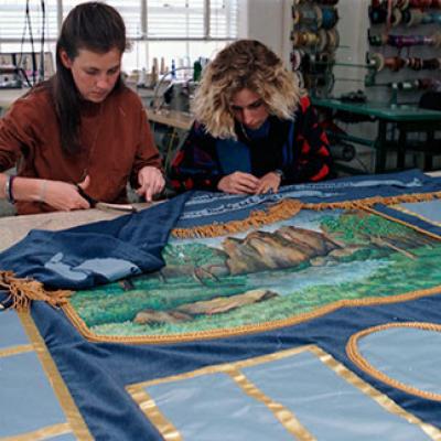 Students of costume and design department, Texas Christian University, work on quilt 