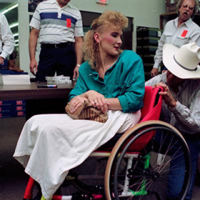 Renea Watson getting her wheelchair autographed by George Strait 