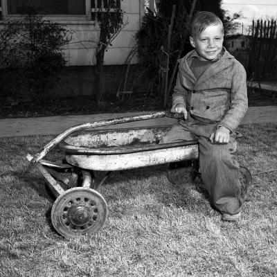 Gerry Tanner playing in a wagon.